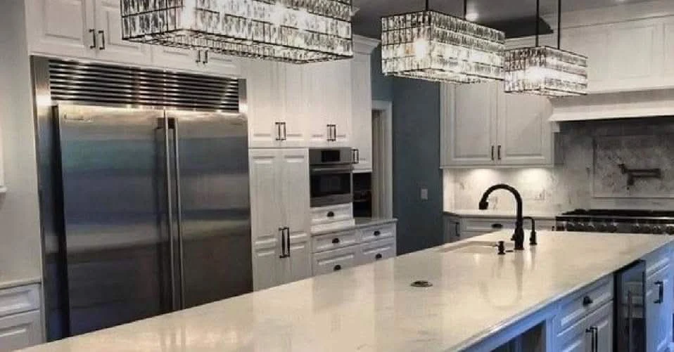 Finished luxury kitchen remodel with white cabinetry and large island